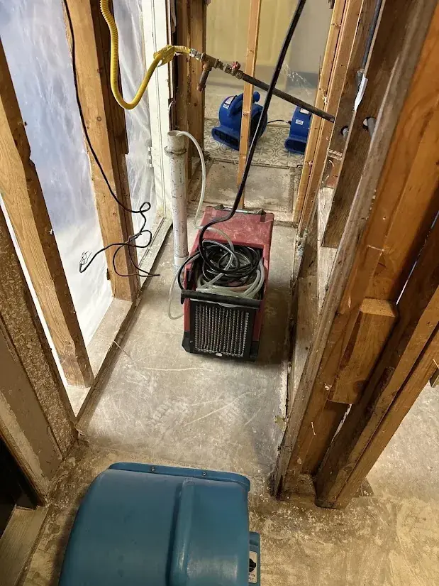 A dehumidifier pulling moisture from a hallway in a Malibu, CA home